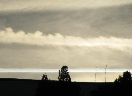 photo: contrails above the mountain horizon